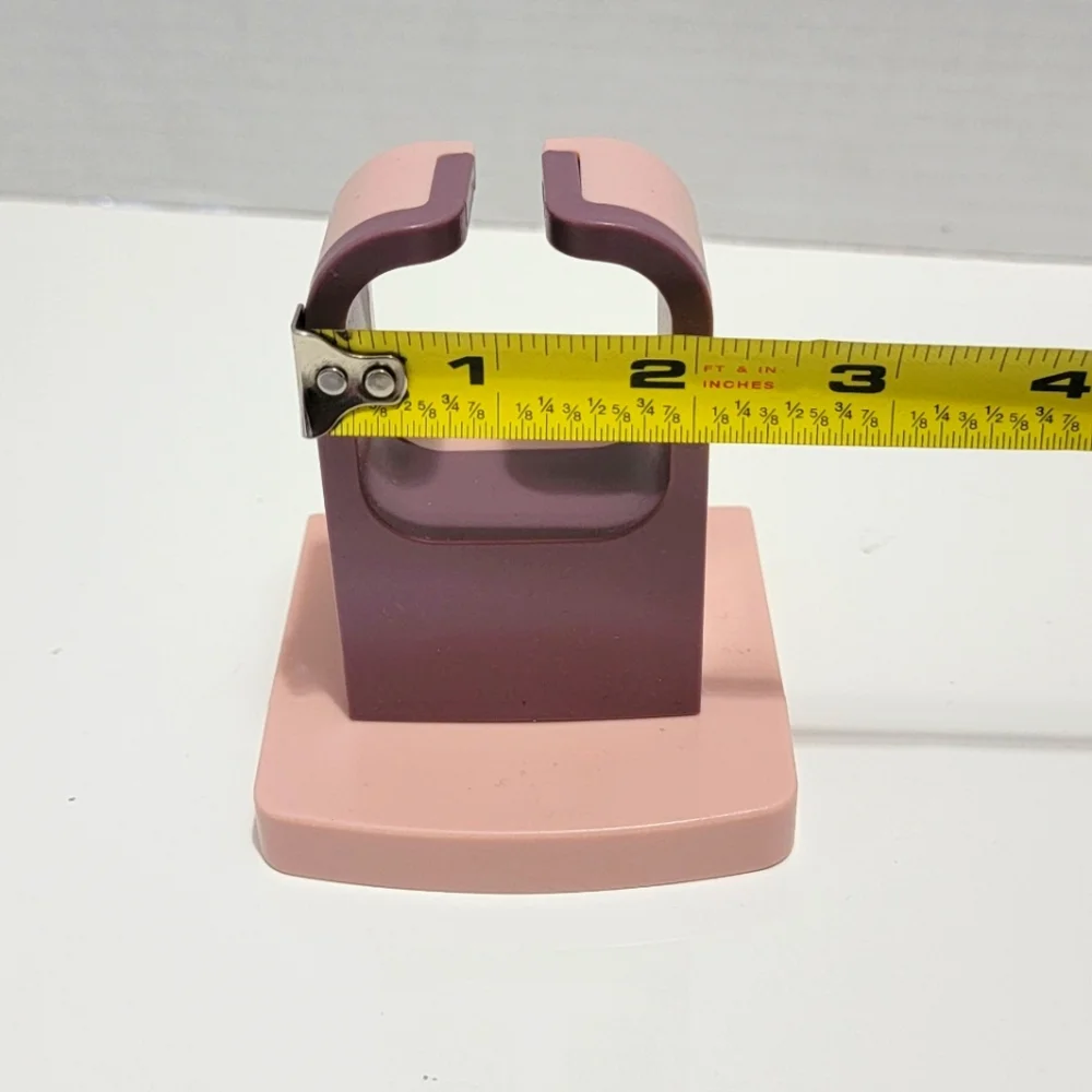 Pink and Purple Wall-Mounted Blow Dryer Holder.